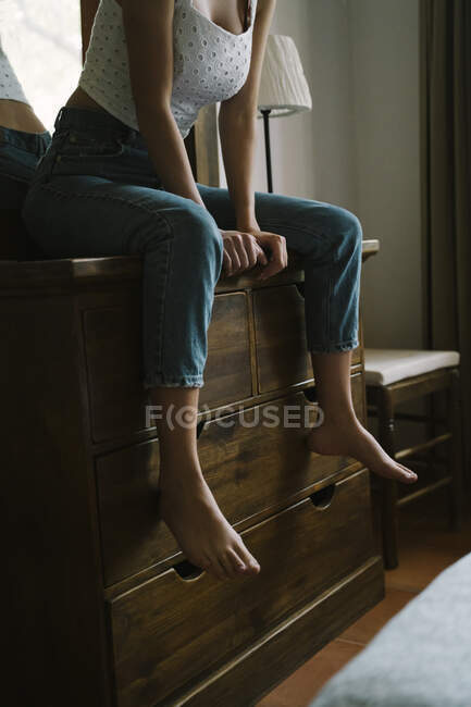 Young woman sitting on dressing table at home — Stock Photo