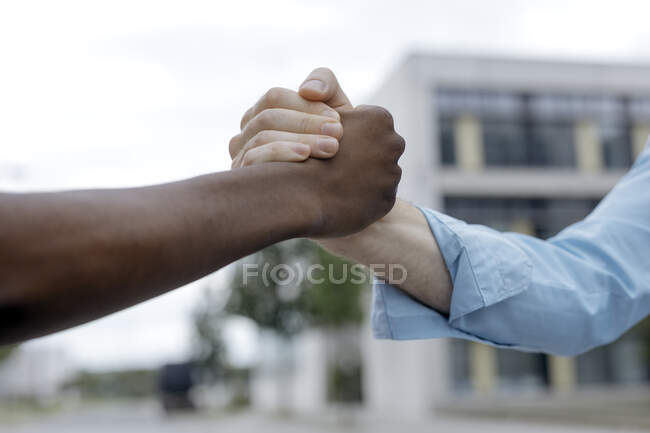 Cropped image of friends bonding in city — Stock Photo