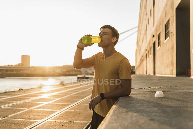 Man drinking water after workout against clear sky — healthy, fitness ...