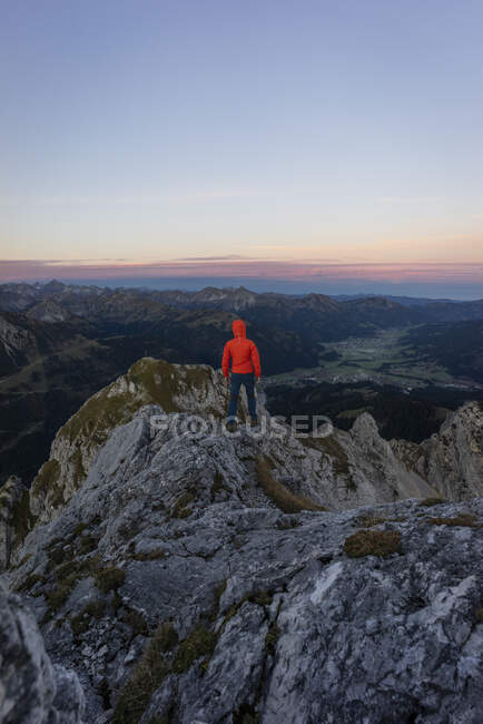 Rear view of hiker on viewpoint during sunrise, Gimpel, Tyrol, Austria — Stock Photo