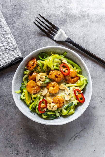 Zoodles with shrimps and chili served in bowl on table — Stock Photo