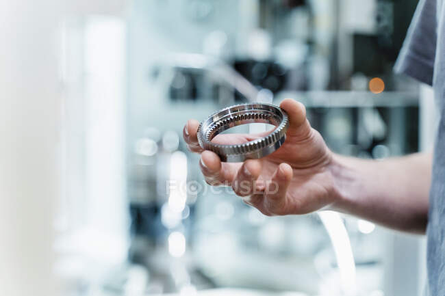 Engineer holding circular machine part at industry — Stock Photo