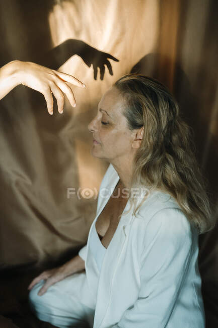 Mão da mulher sobre a mãe sênior durante a sessão reiki — Fotografia de Stock
