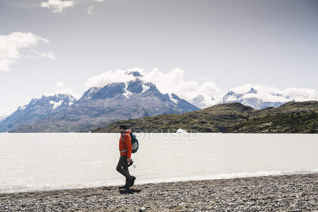 Hombre caminando a orillas del lago en el Parque Nacional Torres Del Paine, Chile, Patagonia, América del Sur - foto de stock