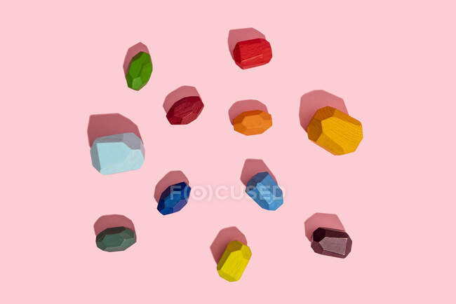 Multi colored wooden blocks against pink background — Stock Photo