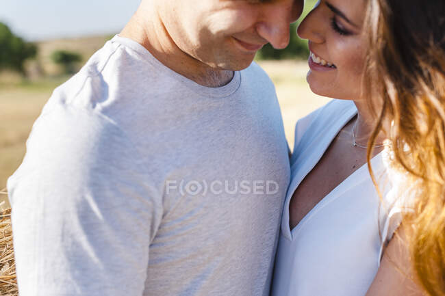 Affectionate couple standing face to face during sunny day — Stock Photo
