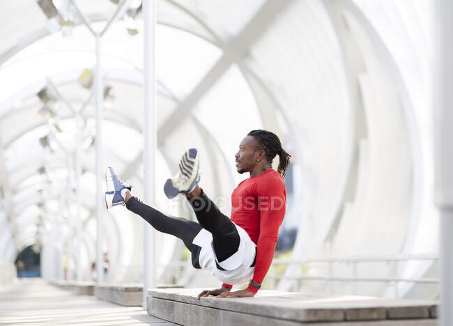 Sportsman balancing while doing handstand on walkway — Stock Photo