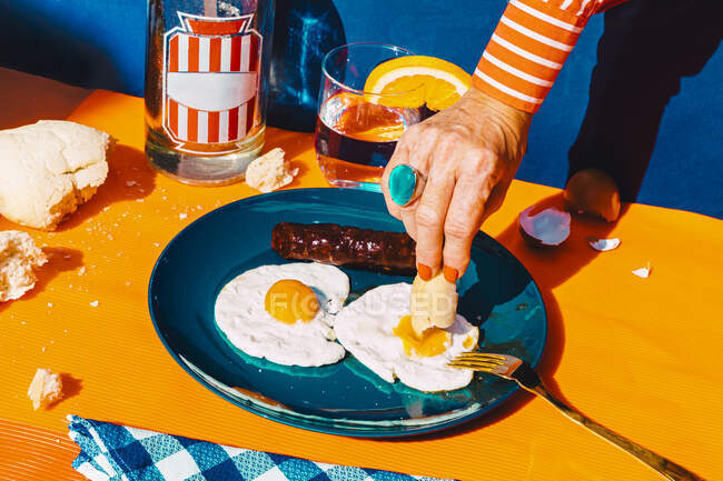 Braccio di donna che mangia uova fritte con chorizo — Foto stock