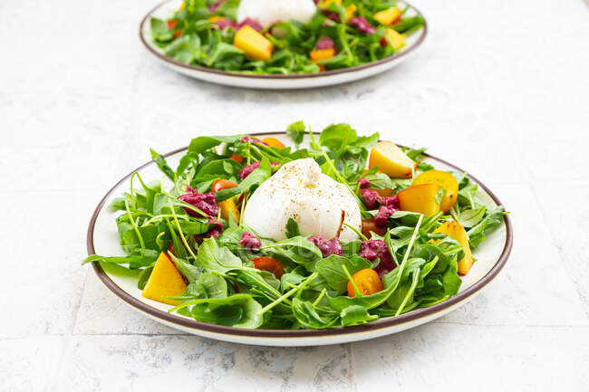 Two plates of vegetarian salad with fruits, vegetables and burrata cheese — Stock Photo
