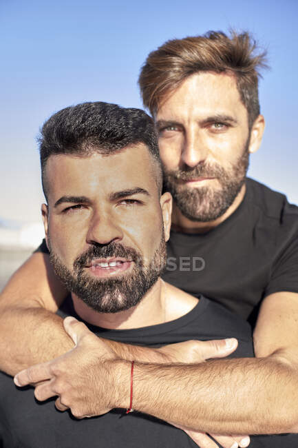 Handsome gay couple spending leisure time together during sunny day — Stock Photo