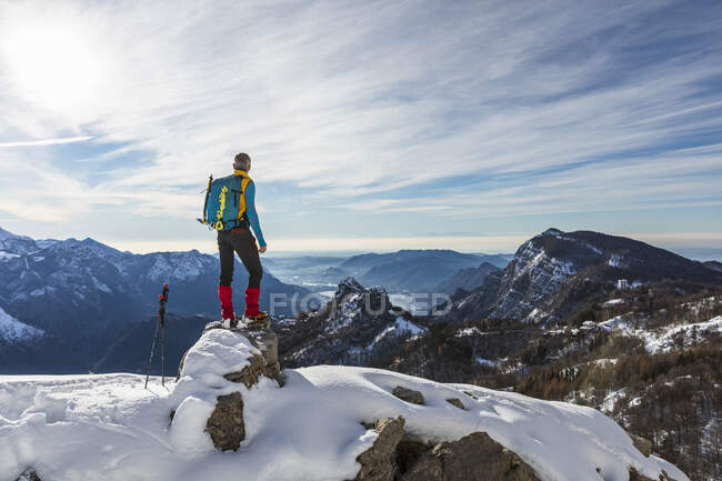 Мужской турист смотрит на вид, стоя на вершине горы, Orobic Альпы, Лекко, Италия — стоковое фото
