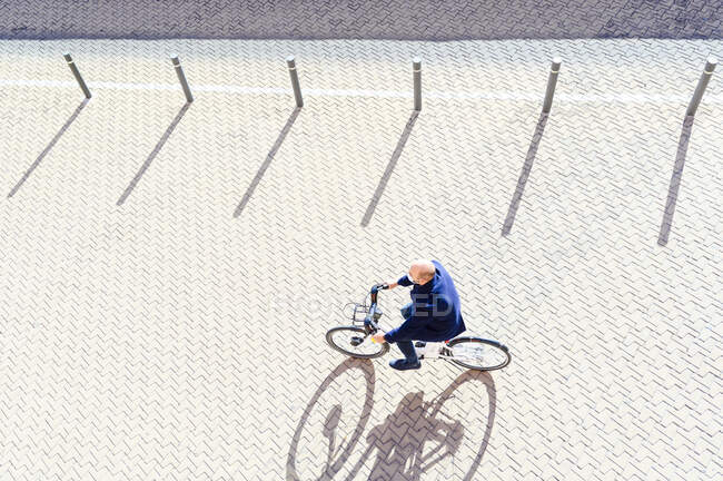 Homem maduro pedalando no dia ensolarado durante a doença pandêmica — Fotografia de Stock