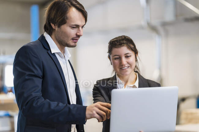 Expertise working on laptop while standing at industry — Stock Photo