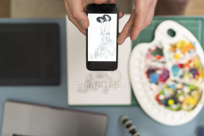 Artista tomando fotos de diseño a través del teléfono móvil en casa - foto de stock