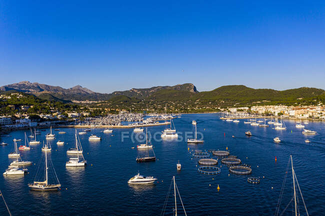 Spain, Balearic Islands, Andratx, Helicopter view of boats sailing near shore of coastal town — Stock Photo