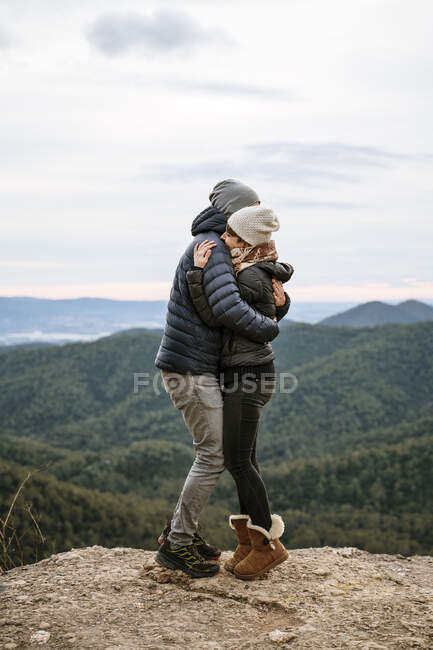 Affectionate couple hugging each other at viewpoint - foto de stock
