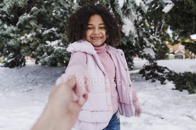 Cute girl holding hand of mother in park during winter — Stock Photo