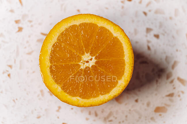 Half orange close-up on a modern terrazzo marble — Stock Photo