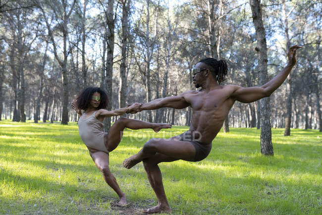 Two professional dancers performing in underwear in middle of forest — Stock Photo
