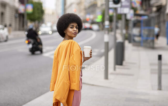 Жіночий хіпстер з чашкою кави на пішохідному шляху — стокове фото