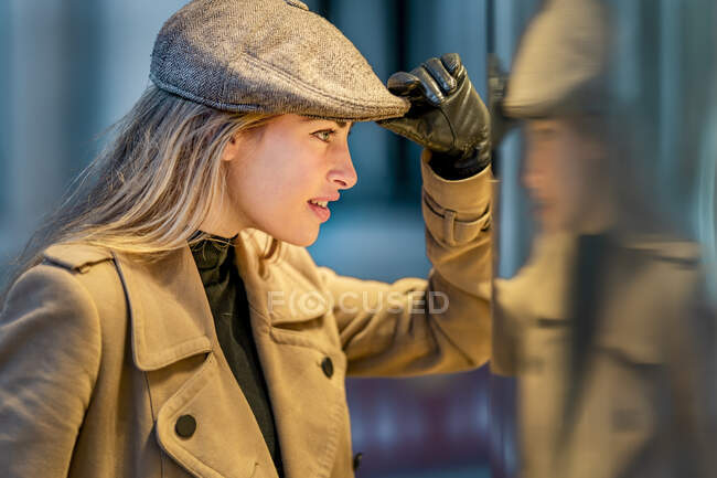 Bella donna guardando in parete materiale di vetro — Foto stock