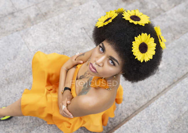 Female hipster with arms crossed sitting on steps — Stock Photo
