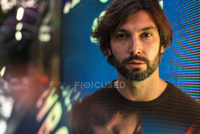 Portrait of man surrounded with digital data — Stock Photo