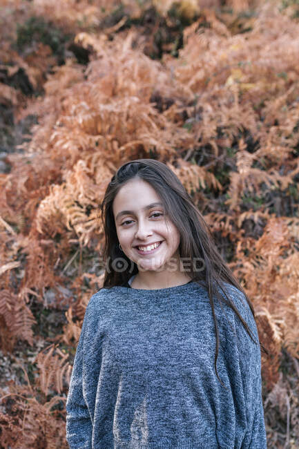 Ritratto di adolescente dai capelli lunghi che sorride alla macchina fotografica — Foto stock