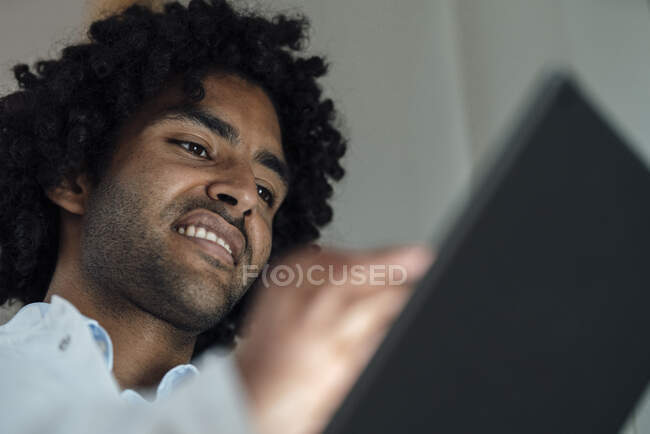 Smiling male healthcare worker using digital tablet at hospital — Stock Photo