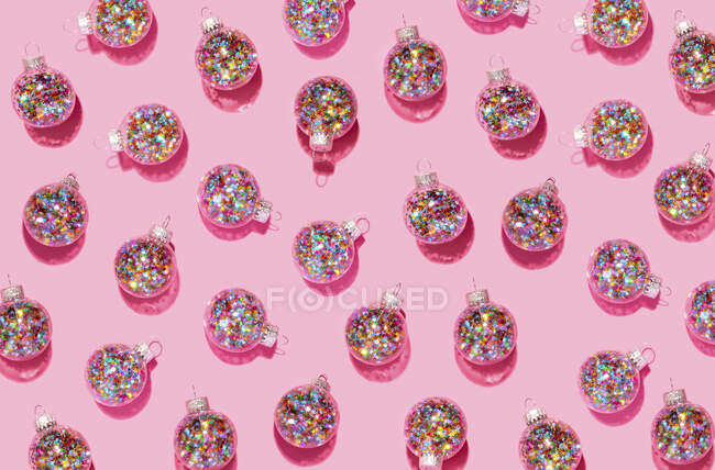 Bright balls for Christmas tree pattern on pink background — Stock Photo