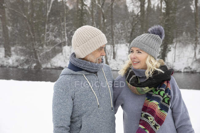 Senior couple in warm clothing looking at each other — Stock Photo