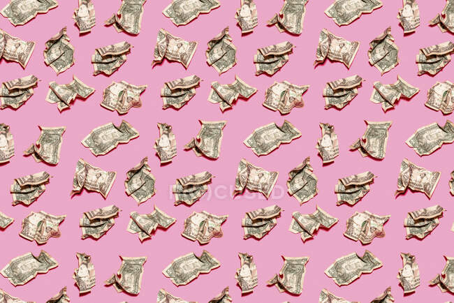 Pattern of crumpled one dollar bills lying against pink background — Stock Photo
