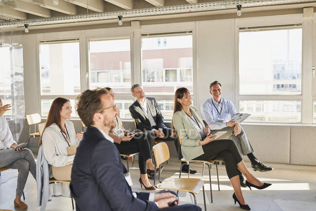 Male and female colleagues attending educational training class at ...