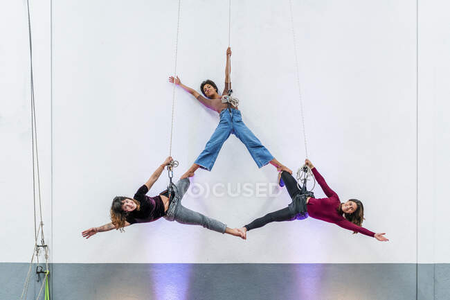 Passionate female dancers practicing while hanging together on rope — Stock Photo