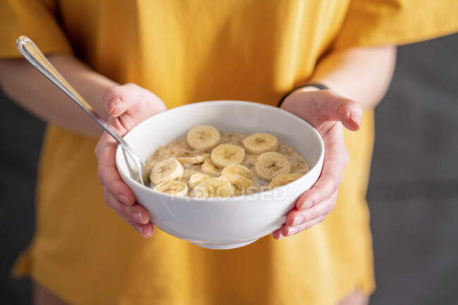 Woman holding breakfast bowl at home — Stock Photo