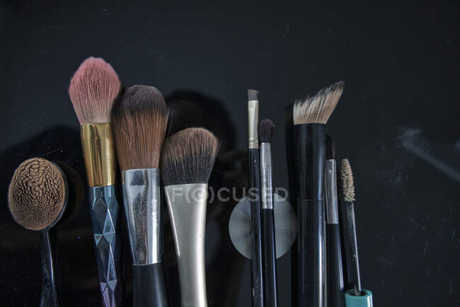 Make-up brushes on black table — Stock Photo