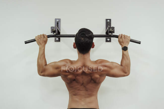 Sportivo che si allena con attrezzature a muro in palestra — Foto stock