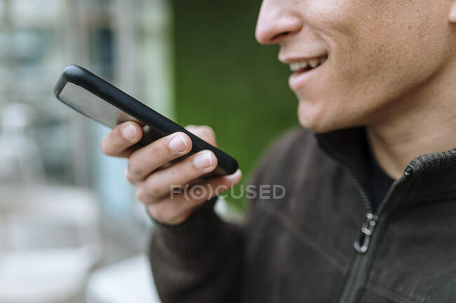 Close up of man sending a voice message with his smartphone — Stock Photo