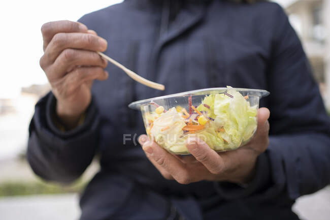 Young man having salad — Stock Photo