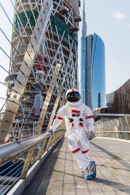 Male astronaut standing on one leg at bridge — Stock Photo