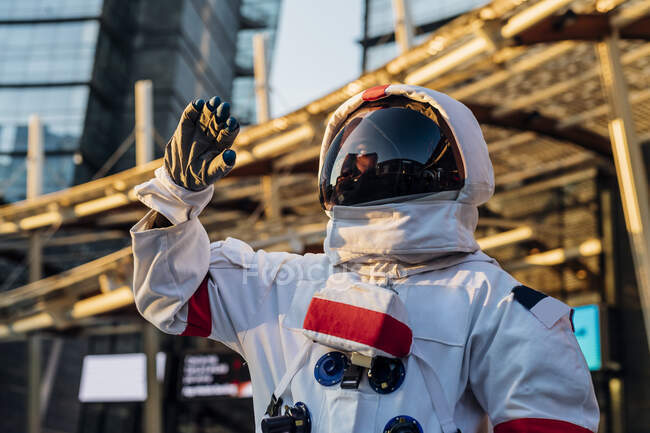 Male astronaut wearing space suit looking away — Stock Photo