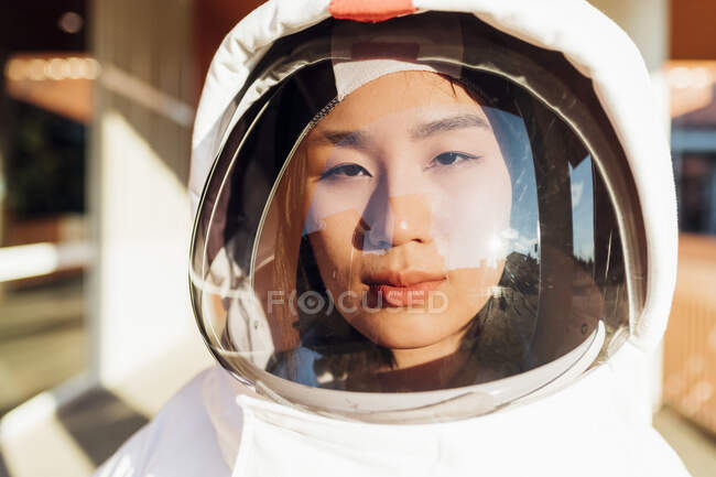Serious female astronaut in space suit during sunny day — Stock Photo
