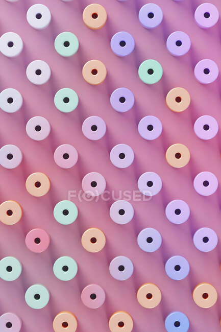 Dreidimensionales Muster pastellfarbener Zylinder vor rosa Hintergrund — Stockfoto