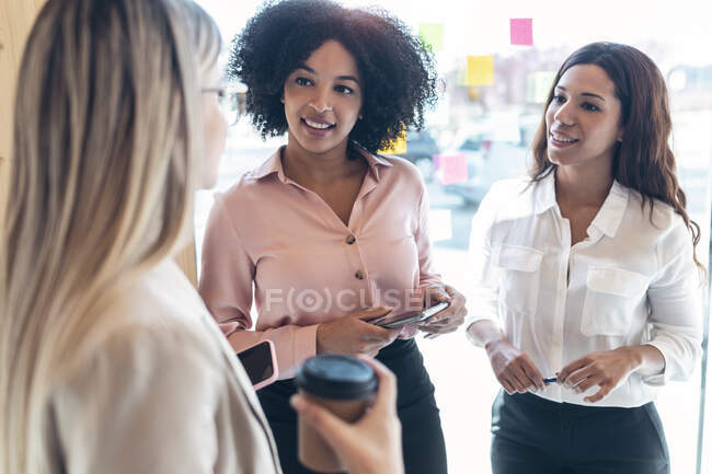 Afro hairstyle businesswoman with coworkers in office — Stock Photo