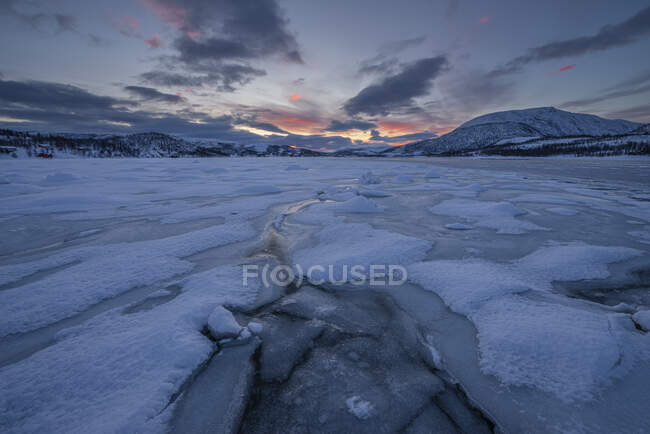 Norway, Tromso, Frozen lake on Senja Island at sunrise — Stock Photo