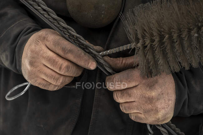 Male chimney sweep holding work tools — Stock Photo