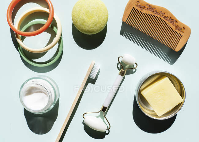 Studio shot of wooden comb, bamboo toothbrush, colorful bracelets, organic soap, shampoo and other eco-friendly self-care products — Stock Photo