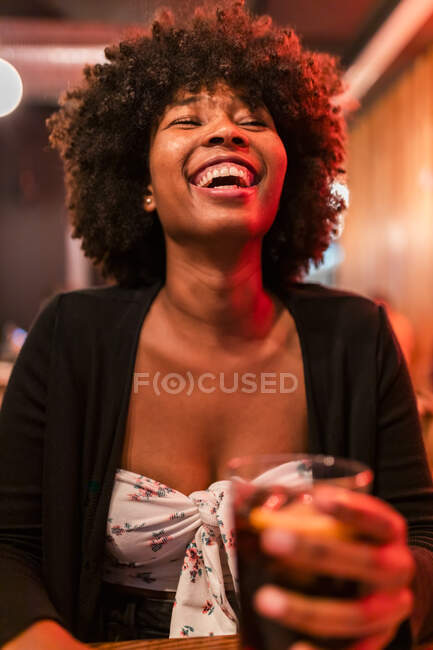Happy Afro woman at bar — Stock Photo