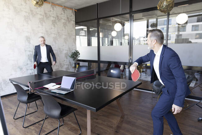 Businessmen playing table tennis at office — Stock Photo
