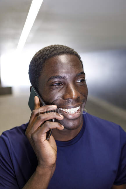 Sonriente hombre hablando en el teléfono móvil en metro - foto de stock